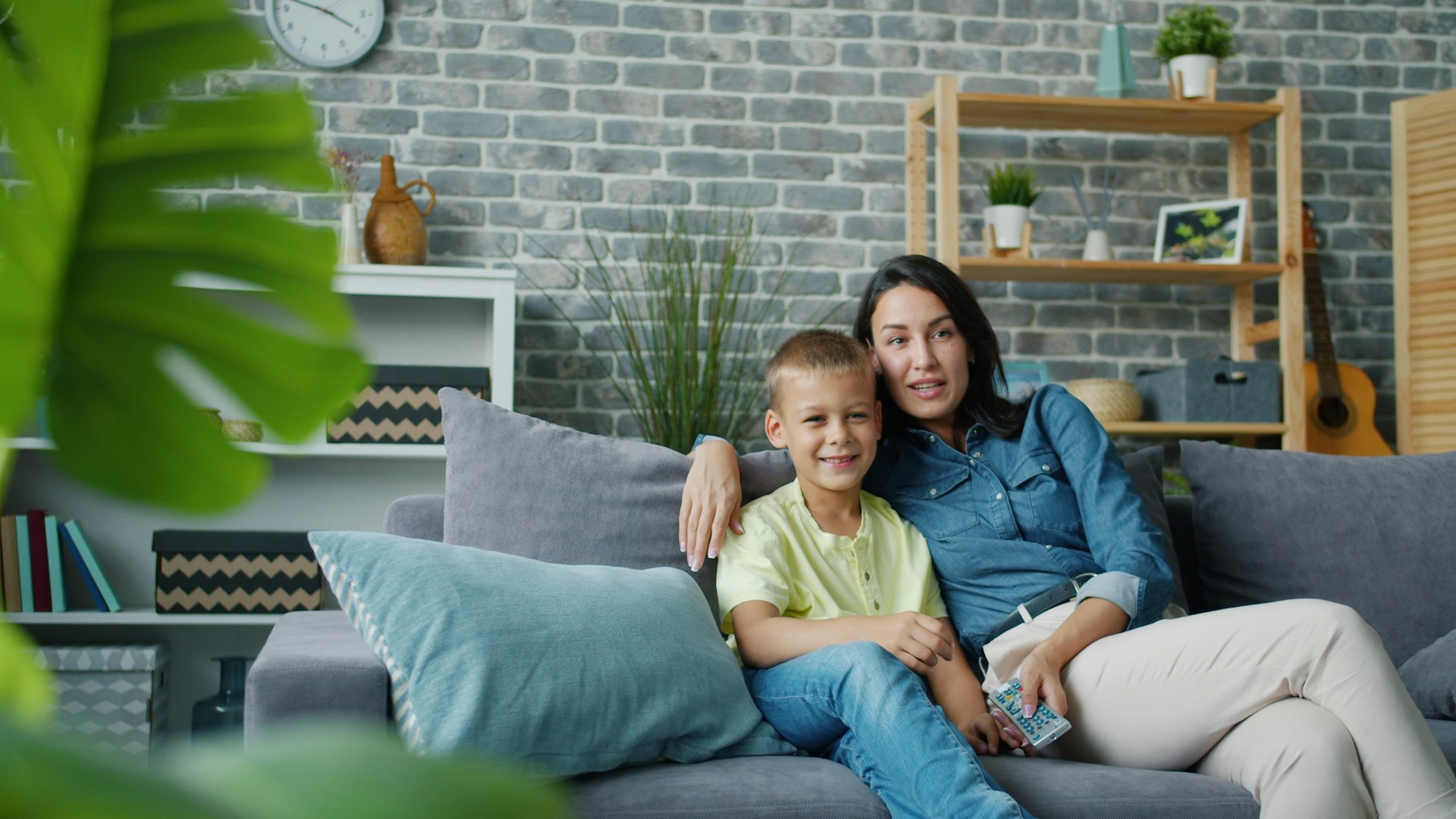A mother and son relaxing on the couch at home